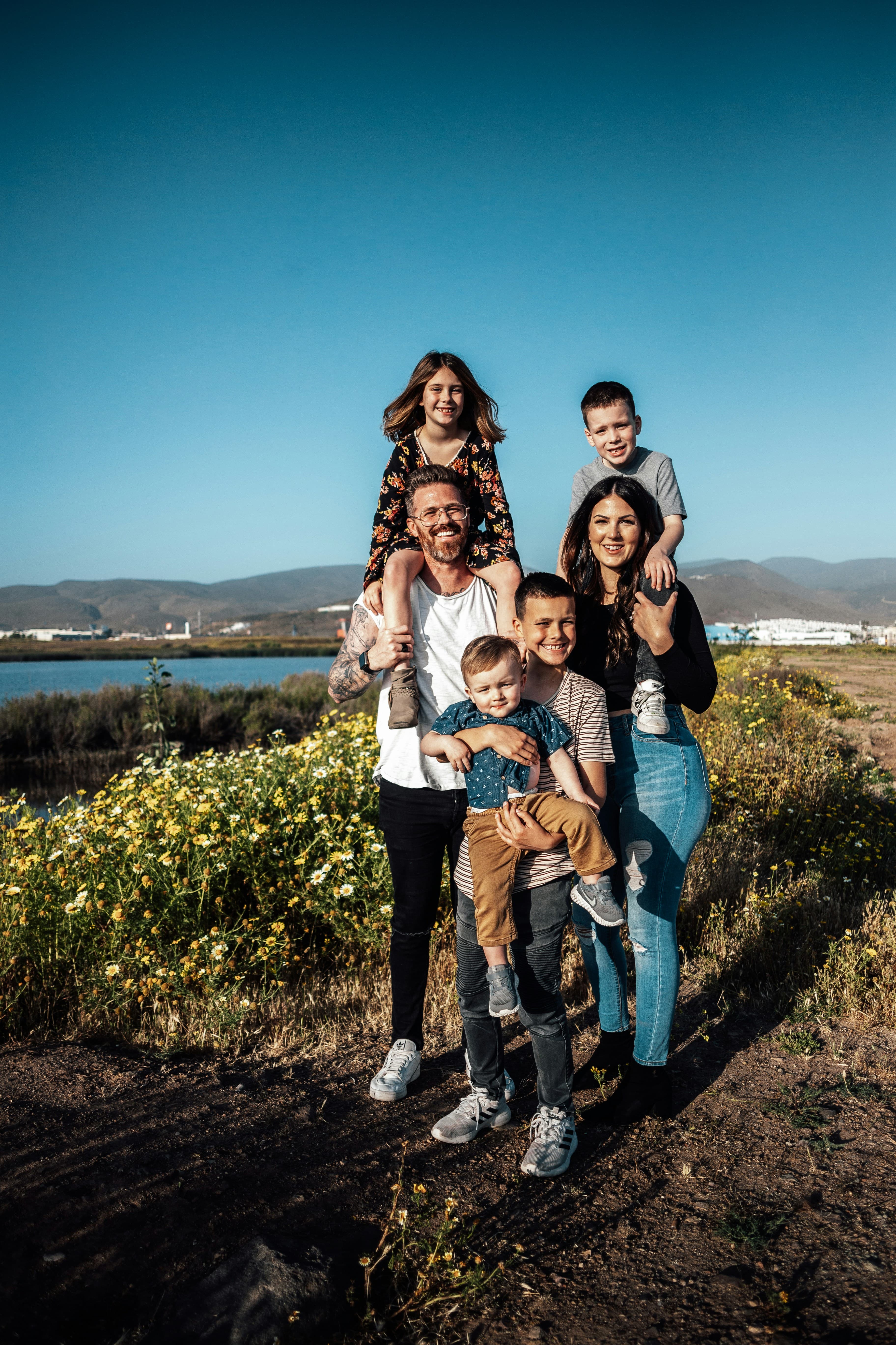 A family standing together outdoors.